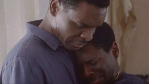 Still from "Beautiful Nightmare" by Kevin Lee Maxwell showing Kelechi Antwone Hugging. SFDFF 2021