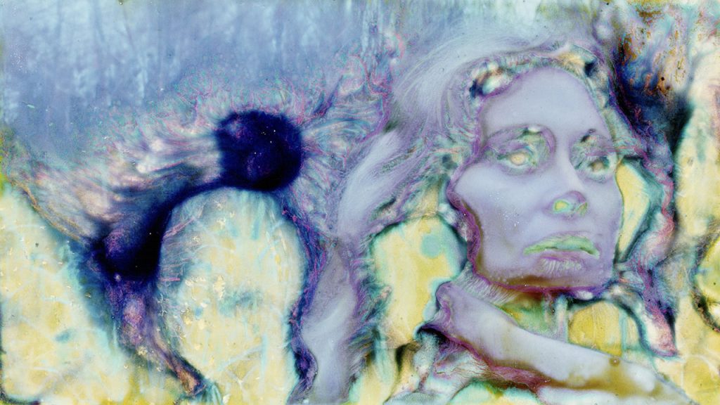 Abstract paint pour, a woman's face, yellow blue and purple, serious expression.