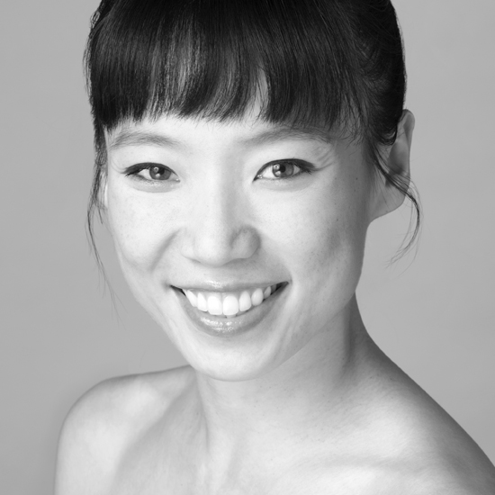 Frances Chung is an Asian woman smiling in a black and white headshot. She has bare shoulders and her black hair is up in a bun with her bangs across her forehead.