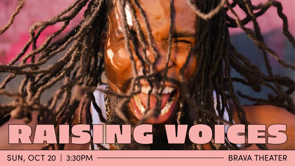 Andrew "3D Dance Fever" Jones yells into the camera with lots of emotion, his hair flying around his face. He is a black man wearing a white sleeveless shirt and stands in front of a pink wall.