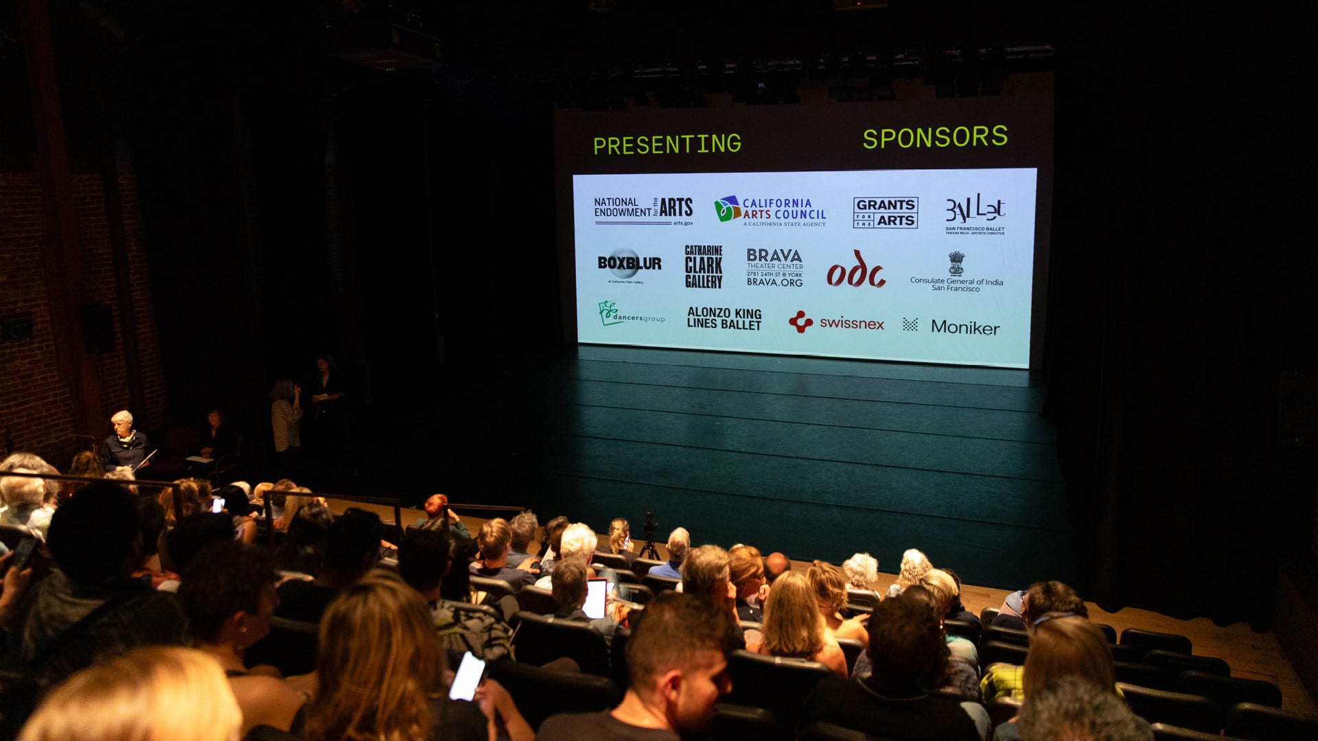 Presenting Sponsor Logos Sponsor logos are projected onto a theater screen